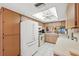 View of kitchen with white appliances and light brown cabinets at 3309 Lori Ln, New Port Richey, FL 34655