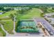 Aerial view showing tennis courts near a golf course and other buildings at 3309 Lori Ln, New Port Richey, FL 34655