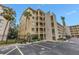 Multi-story condo building with balconies and parking; mature palm trees enhance the landscape at 3500 Lake Bayshore Dr # K-101, Bradenton, FL 34205