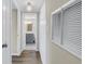 Hallway with wood floors leading to a bathroom and closets at 3500 Lake Bayshore Dr # K-101, Bradenton, FL 34205