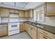 The kitchen offers light wood cabinets, granite countertops, and stainless steel appliances at 3500 Lake Bayshore Dr # K-101, Bradenton, FL 34205