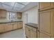 Kitchen with neutral cabinets, granite countertops, and tile flooring at 3500 Lake Bayshore Dr # K-101, Bradenton, FL 34205
