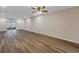 Open concept living room with wood floors, lots of natural light, and access to the screened lanai at 3500 Lake Bayshore Dr # 101, Bradenton, FL 34205