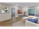 Bright living room with modern decor, wood floors, and a sliding glass door to the outdoors at 3500 Lake Bayshore Dr # K-101, Bradenton, FL 34205