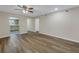 Living room with wood floors, a ceiling fan, and an open floorplan that leads to the kitchen at 3500 Lake Bayshore Dr # K-101, Bradenton, FL 34205