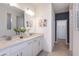 Double vanity bathroom with white cabinets, quartz countertop, and a walk-in closet at 4202 Big Sky Dr, Spring Hill, FL 34604