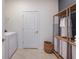 Laundry room with washer, dryer, and built-in shelving at 4202 Big Sky Dr, Spring Hill, FL 34604