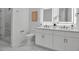 Elegant bathroom featuring double vanity, modern fixtures, and a glass-enclosed shower at 600 3Rd S Ave # 401, St Petersburg, FL 33701
