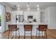 Modern kitchen featuring white cabinets, stainless steel appliances, and stylish barstool seating at 600 3Rd S Ave # 401, St Petersburg, FL 33701
