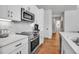 Bright kitchen features stainless steel appliances, white cabinetry, and hardwood floors at 600 3Rd S Ave # 401, St Petersburg, FL 33701