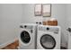 Efficient laundry room with a side-by-side washer and dryer, and a hardwood floor at 600 3Rd S Ave # 401, St Petersburg, FL 33701
