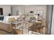 Open concept dining room, adjacent to the living room, features a modern glass table with seating for eight at 600 3Rd S Ave # 405, St Petersburg, FL 33701