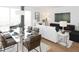 Open concept living space with dining area featuring a glass table and a living room with plush seating at 600 3Rd S Ave # 405, St Petersburg, FL 33701