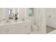 Modern bathroom with double sinks, a marble countertop, a luxurious robe, and a glass-enclosed shower at 600 3Rd S Ave # 506, St Petersburg, FL 33701