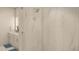 Walk-in shower is fully-tiled with marble and has a glass door, with the dual sink vanity in view at 600 3Rd S Ave # 506, St Petersburg, FL 33701