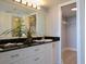 Elegant bathroom with dark countertop and linen closet at 6372 Palma Del Mar S Blvd # 705, St Petersburg, FL 33715