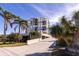 High-rise building with palm trees and parking area at 6372 Palma Del Mar S Blvd # 705, St Petersburg, FL 33715