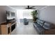 Living room with gray couch and large TV at 6372 Palma Del Mar S Blvd # 705, St Petersburg, FL 33715
