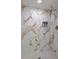 Modern shower with marble-style walls and a mosaic tile floor at 6372 Palma Del Mar S Blvd # 705, St Petersburg, FL 33715