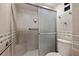 Shower with built-in seat and tiled walls at 7432 Sunshine Skyway S Ln # 402, St Petersburg, FL 33711