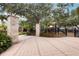 An inviting community entrance with stone pillars, manicured landscaping, and a view of the playground at 805 Islebay Dr, Apollo Beach, FL 33572