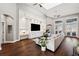 Spacious living room with a vaulted ceiling, ceiling fan, and a custom built-in entertainment center at 805 Islebay Dr, Apollo Beach, FL 33572