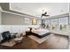 Bright main bedroom with tray ceilings, wood floors, and lots of natural light at 805 Islebay Dr, Apollo Beach, FL 33572