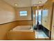 Bathroom with large soaking tub and walk-in shower at 820 Gulf Blvd # S 1-3, Indian Rocks Beach, FL 33785
