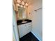 Small bathroom with granite vanity and black tile floor at 820 Gulf Blvd # S 1-3, Indian Rocks Beach, FL 33785