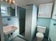 Clean bathroom with light teal tile, shower, sink, and toilet at 820 Gulf Blvd # S 1-3, Indian Rocks Beach, FL 33785