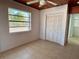 Bedroom with large window, tile floor, and double door closet at 820 Gulf Blvd # S 1-3, Indian Rocks Beach, FL 33785