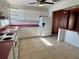 Kitchen with white cabinets, pink countertops, and white appliances at 820 Gulf Blvd # S 1-3, Indian Rocks Beach, FL 33785