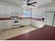 Kitchen with white cabinets, pink countertops, and white appliances at 820 Gulf Blvd # S 1-3, Indian Rocks Beach, FL 33785