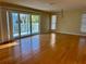 Living room with hardwood floors and sliding glass doors leading to a deck at 820 Gulf Blvd # S 1-3, Indian Rocks Beach, FL 33785