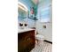 Clean bathroom with white tile, dark vanity, and a small window at 115 Athens St, Tarpon Springs, FL 34689