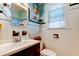 White tiled bathroom with a dark wood vanity and shower/tub combo at 115 Athens St, Tarpon Springs, FL 34689
