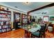Charming dining room with hardwood floors, glass table, and built-in shelving at 115 Athens St, Tarpon Springs, FL 34689