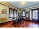 Cozy dining area with hardwood floors, a glass-top table, and built-in shelves at 115 Athens St, Tarpon Springs, FL 34689
