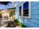 Light blue house exterior with a rocking chair and small patio at 115 Athens St, Tarpon Springs, FL 34689