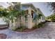 Light blue house with brick accents, front porch, and landscaped yard at 115 Athens St, Tarpon Springs, FL 34689
