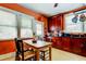 Bright kitchen with wood cabinets, a farmhouse table and view to living area at 115 Athens St, Tarpon Springs, FL 34689