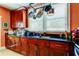 Kitchen with dark wood cabinets, granite countertops, and a pot rack at 115 Athens St, Tarpon Springs, FL 34689