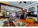 Spacious living room with hardwood floors, built-in shelving, and a large TV at 115 Athens St, Tarpon Springs, FL 34689