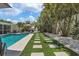 Landscaped backyard with a refreshing pool and stone pathway at 1340 Westway Dr, Sarasota, FL 34236