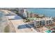 Aerial view of beachfront property, showcasing multiple buildings and a swimming pool at 1400 Gulf Blvd # 406, Clearwater Beach, FL 33767