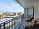 Relaxing balcony with patio furniture and waterfront view at 1400 Gulf Blvd # 406, Clearwater Beach, FL 33767