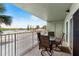 Enjoy water views from this condo's balcony, featuring a table and chairs at 18610 Gulf Blvd # 108, Indian Shores, FL 33785