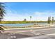 Scenic waterfront view with palm trees and road at 18610 Gulf Blvd # 108, Indian Shores, FL 33785