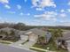 Two-story home with double garage and palm trees; community view in background at 19315 Hawk Valley Dr, Tampa, FL 33647