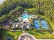 Aerial view of community amenities including pool, tennis courts, and clubhouse at 19315 Hawk Valley Dr, Tampa, FL 33647